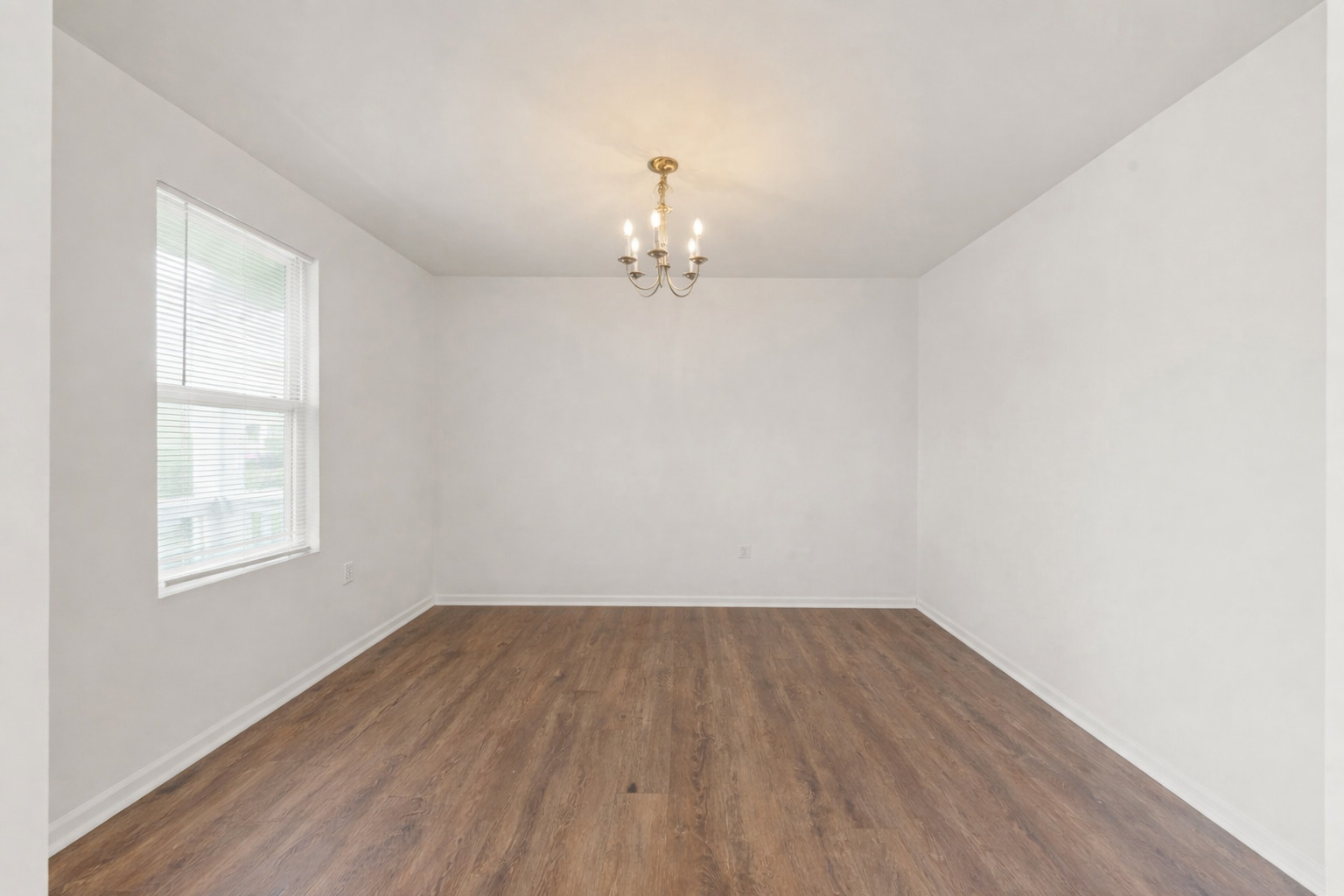 114 Schmidt Court Plano, IL 60545 - Photo 3 of 18 an empty room with wooden floor and windows