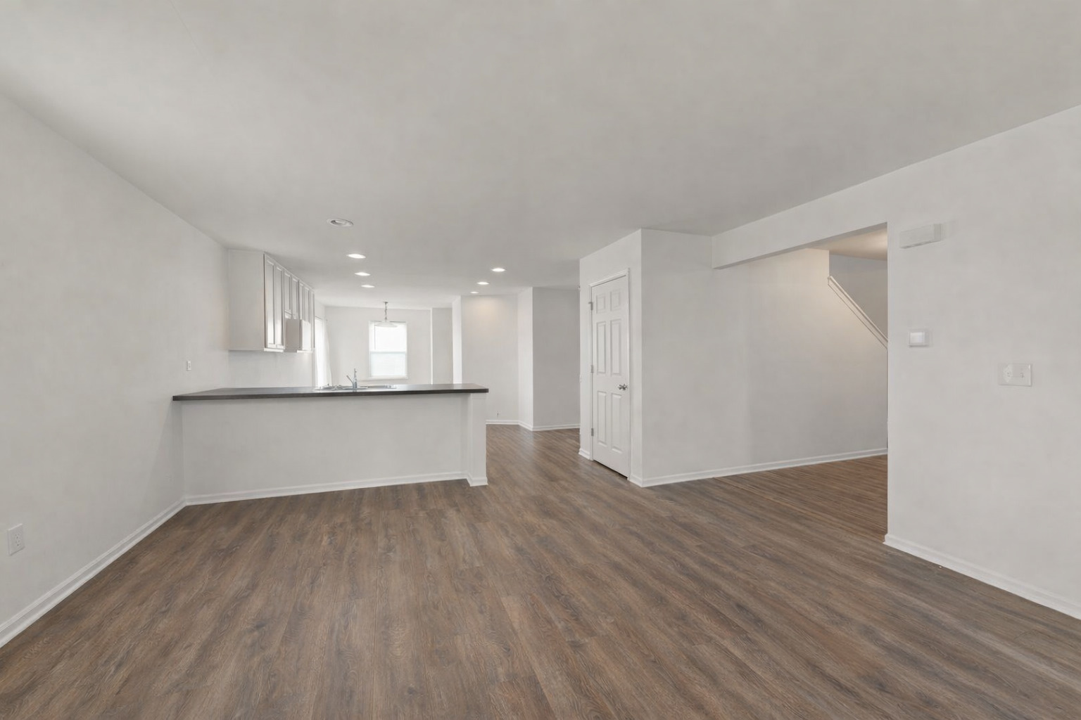 114 Schmidt Court Plano, IL 60545 - Photo 5 of 18 a view of an empty room with wooden floor