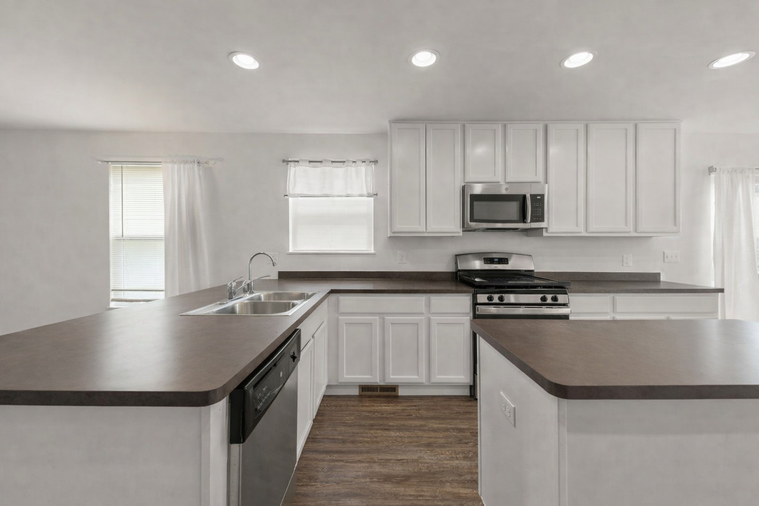 114 Schmidt Court Plano, IL 60545 - Photo 6 of 18 a kitchen with kitchen island granite countertop a sink and stainless steel appliances