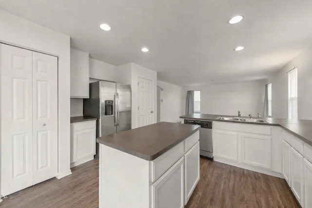 a kitchen with a center island and stainless steel appliances