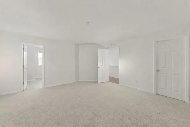 a view of an empty room and closet area