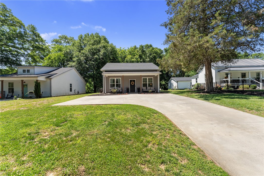 47 A Main Street Pelzer, SC 29669 - Photo 2 of 27 This charming residence features a well-maintained exterior and a spacious driveway.