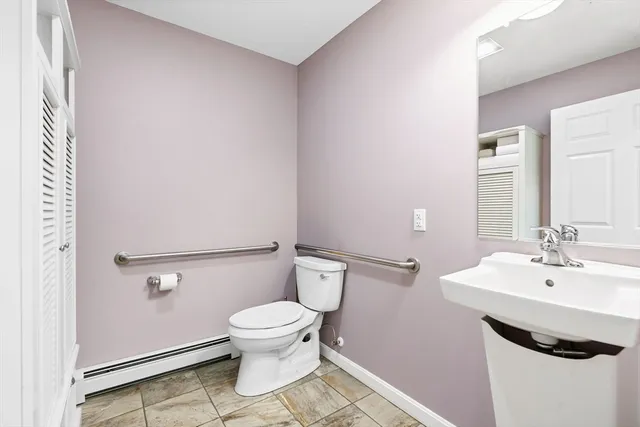 a bathroom with a sink a toilet and a mirror