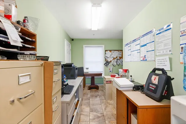 a work room with furniture and a flat screen tv
