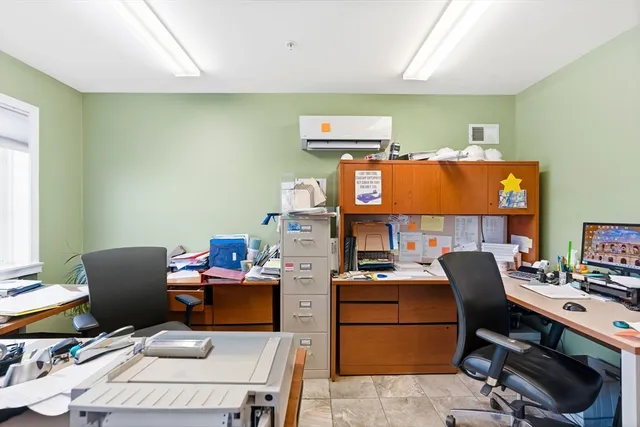 a work room with furniture and a window