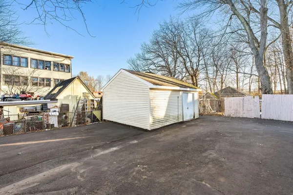 a view of a house with a yard and wooden fence