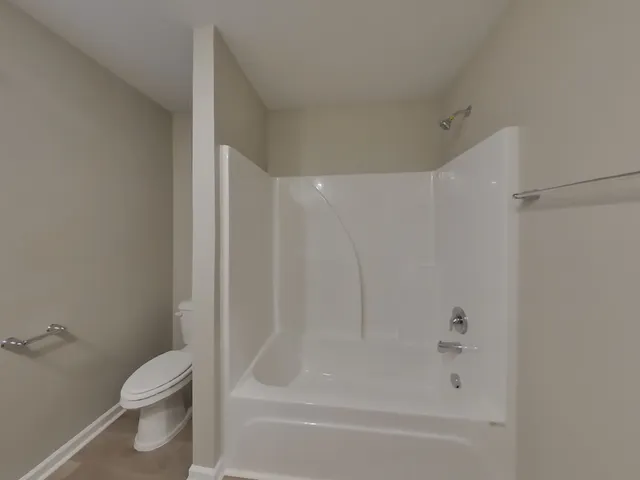 a bathroom with a bathtub and a toilet