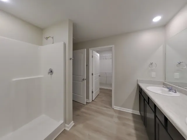 a spacious bathroom with a shower and a sink