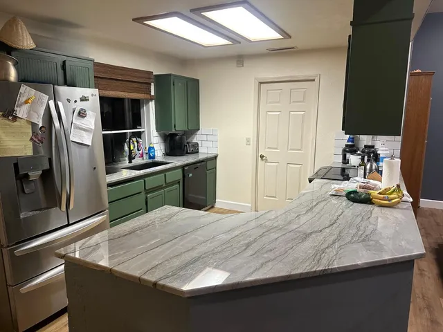 a room with a bed and a television