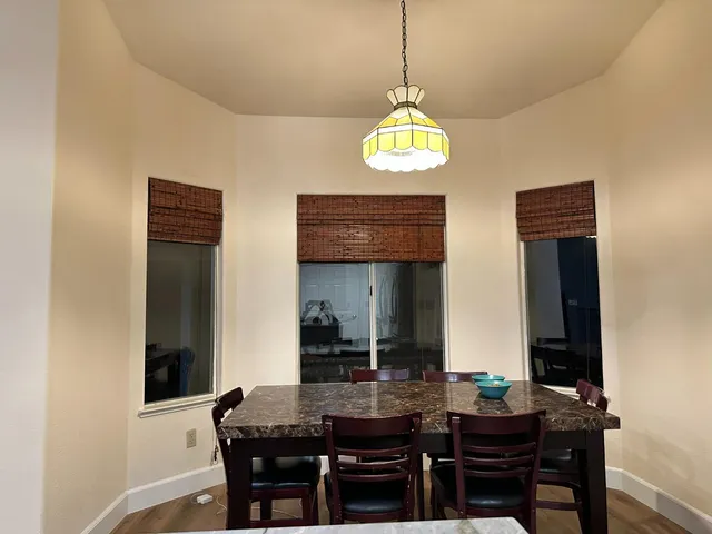 a view of a dining room with furniture and chandelier