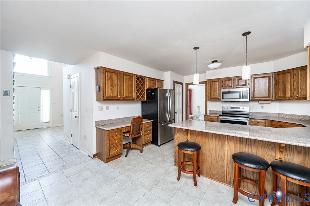 8902 Duchess Way Chesterfield, VA 23832 - Photo 14 of 34 a kitchen with stainless steel appliances granite countertop a sink and a refrigerator