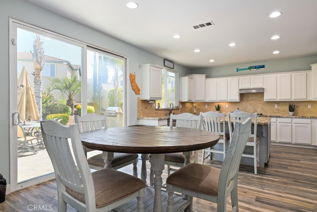 31319 Locust Court Temecula, CA 92592 - Photo 15 of 75 a view of a dining room with furniture window and wooden floor