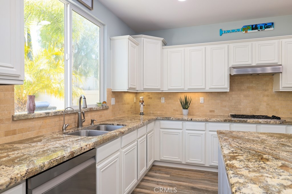 31319 Locust Court Temecula, CA 92592 - Photo 18 of 75 a kitchen with granite countertop a sink and a window