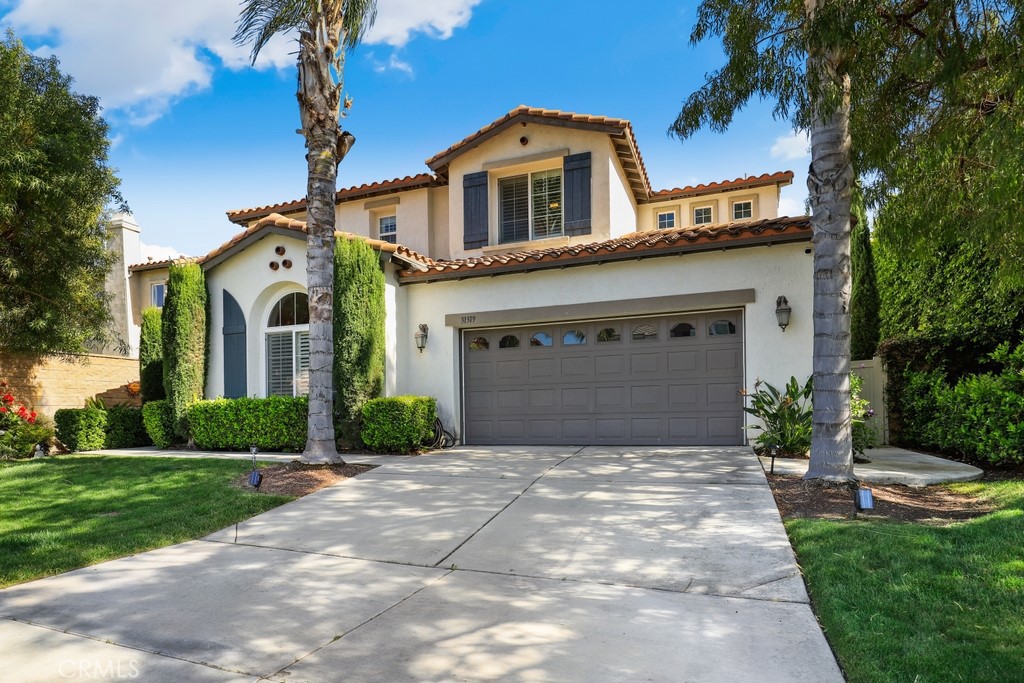 31319 Locust Court Temecula, CA 92592 - Photo 2 of 75 a front view of a house with a yard and garage
