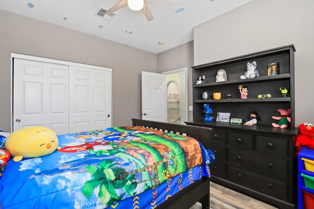 31319 Locust Court Temecula, CA 92592 - Photo 37 of 75 a bedroom with a bed a dresser and painting on the wall