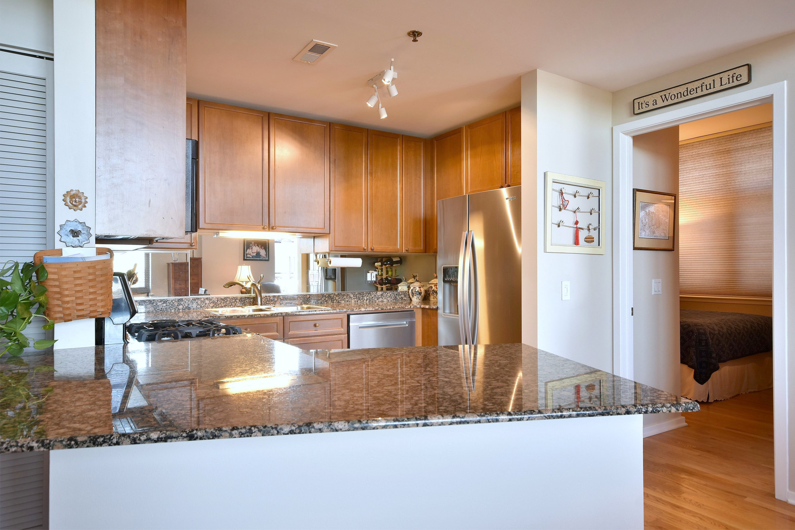 1201 West Adams Street, Unit 411 Chicago, IL 60607 - Photo 11 of 40 a kitchen with kitchen island granite countertop a refrigerator a stove and a sink cabinets