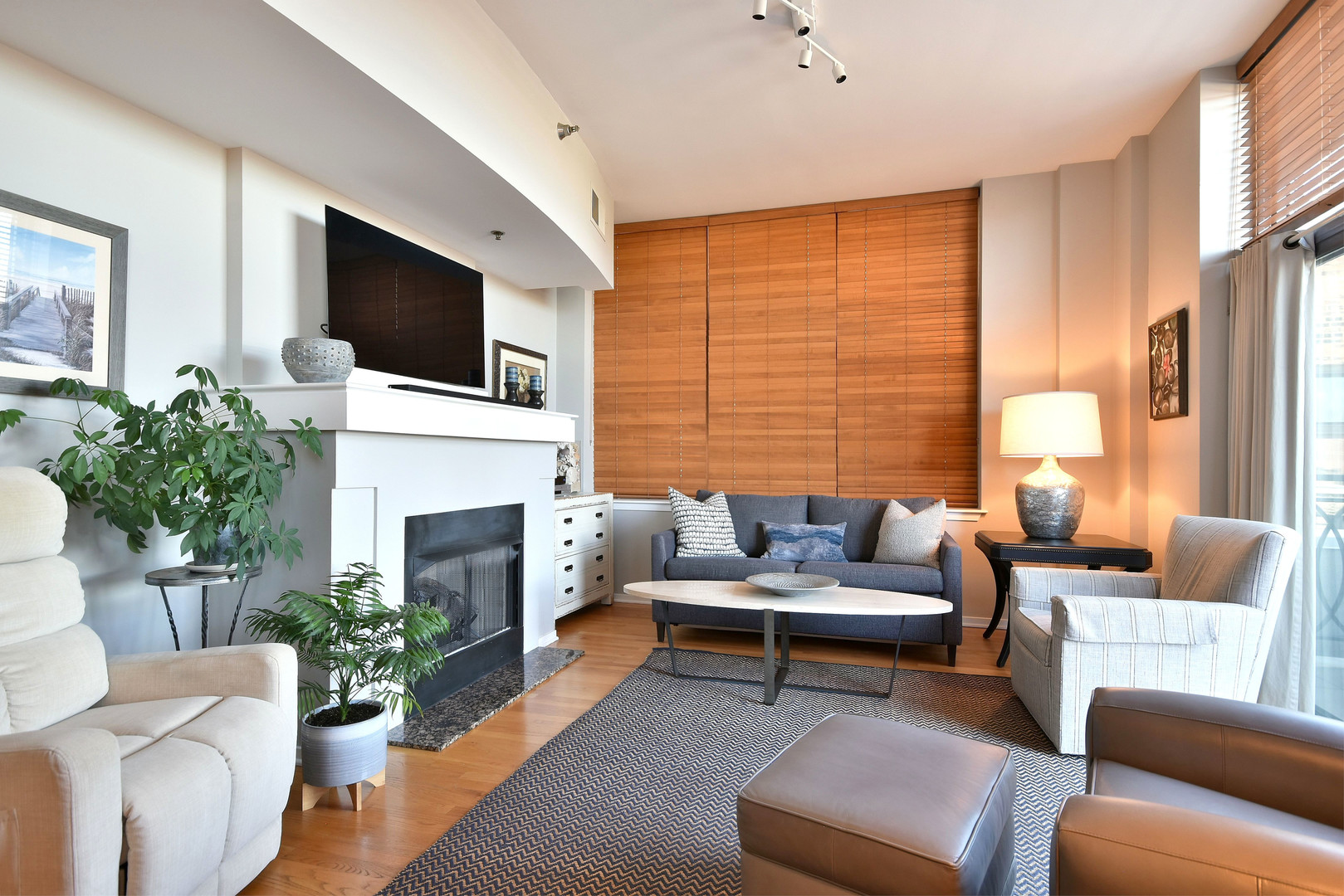 1201 West Adams Street, Unit 411 Chicago, IL 60607 - Photo 15 of 40 a living room with furniture a fireplace and a flat screen tv