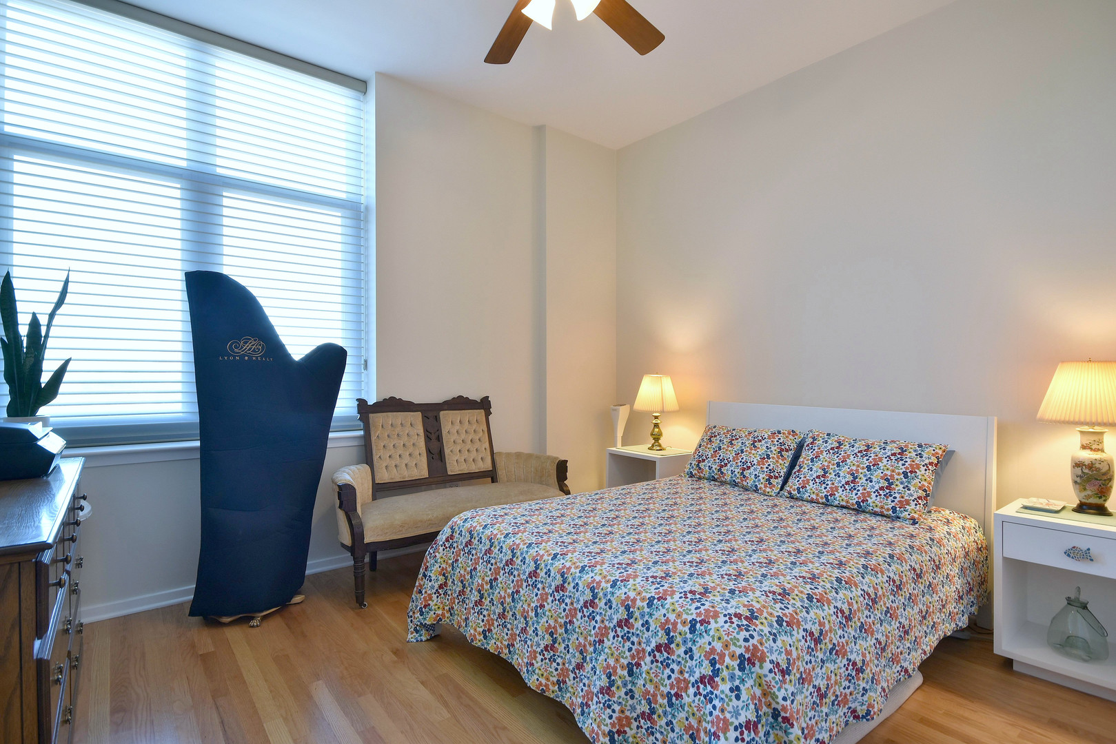 1201 West Adams Street, Unit 411 Chicago, IL 60607 - Photo 22 of 40 a bedroom with a bed and a chandelier
