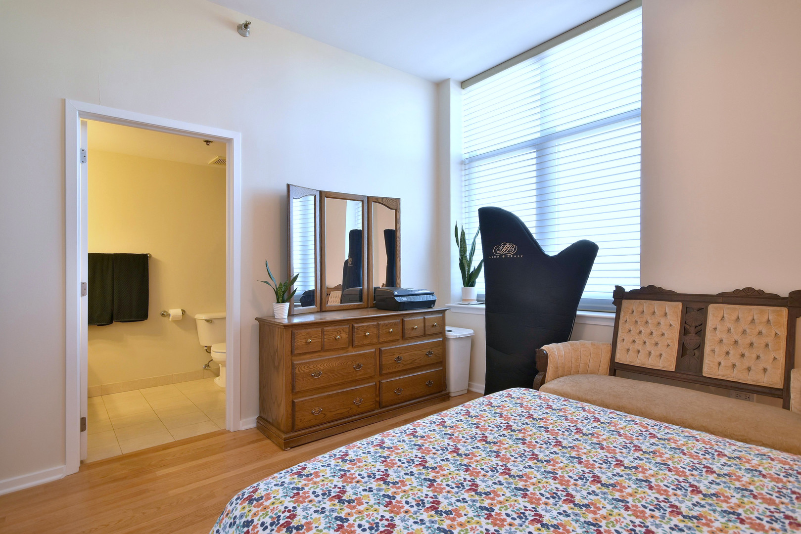 1201 West Adams Street, Unit 411 Chicago, IL 60607 - Photo 24 of 40 a bedroom with a bed and wooden floor
