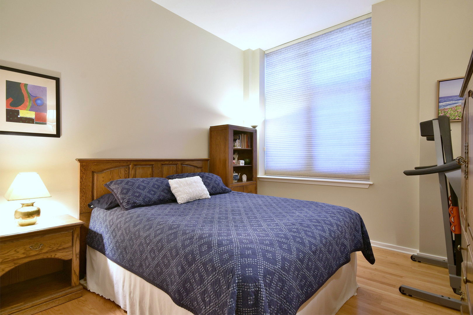 1201 West Adams Street, Unit 411 Chicago, IL 60607 - Photo 27 of 40 a bedroom with a bed and a flat tv screen on a dresser