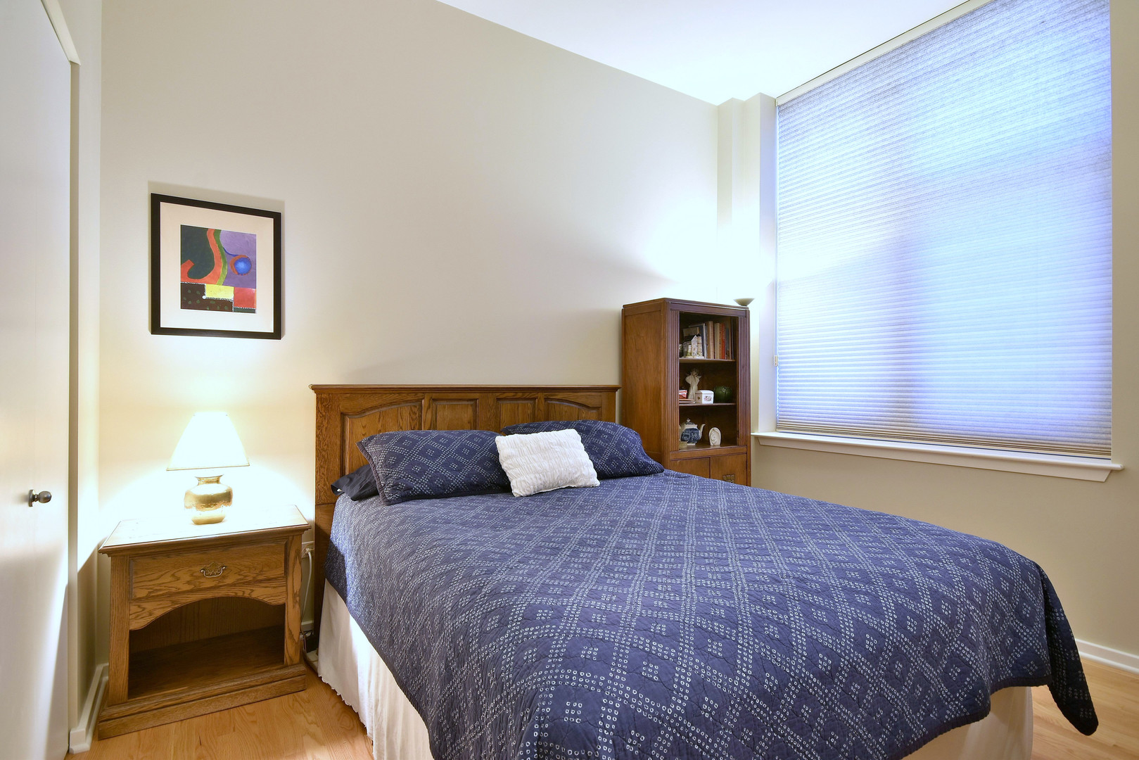 1201 West Adams Street, Unit 411 Chicago, IL 60607 - Photo 28 of 40 a bedroom with a bed and a chair