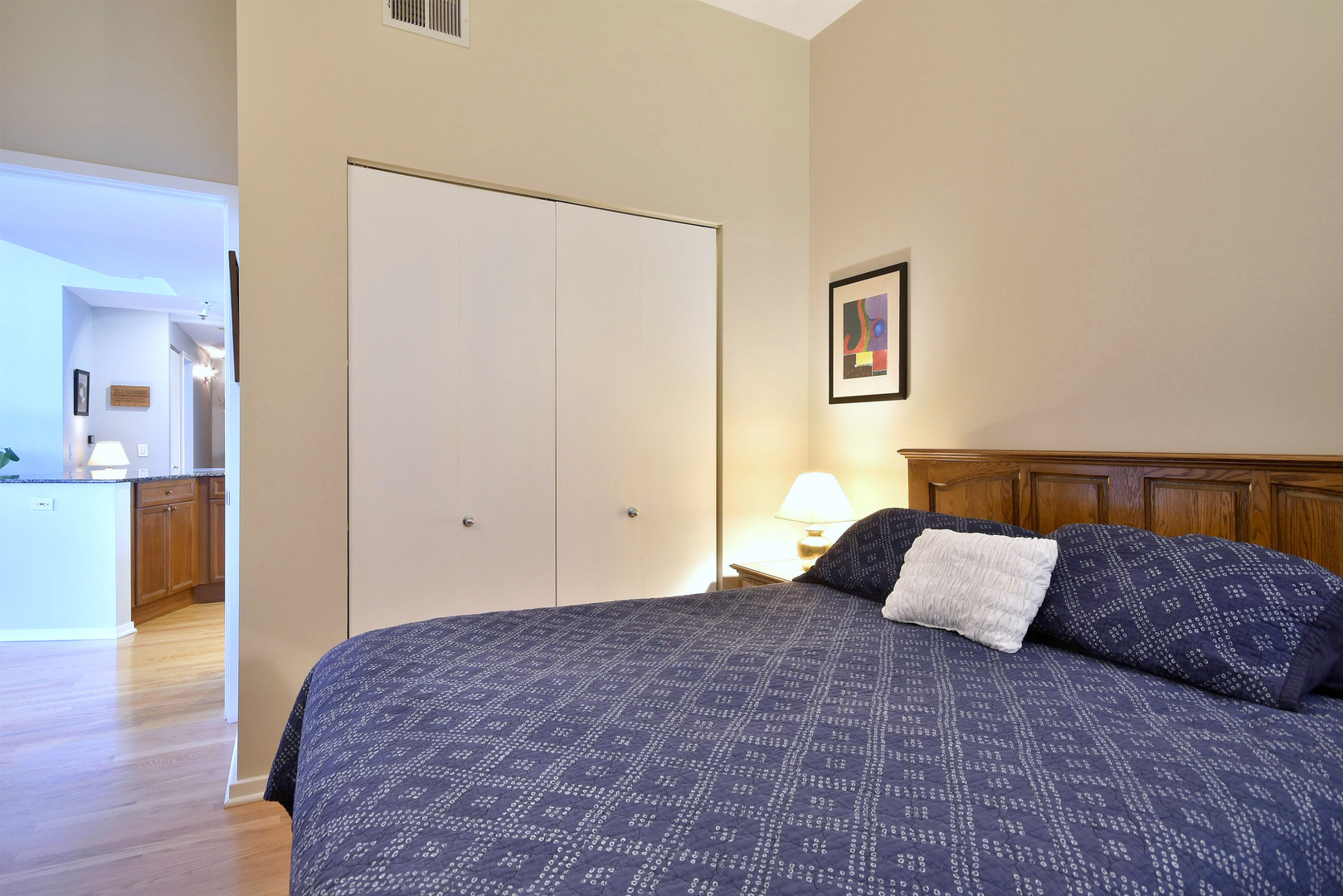 1201 West Adams Street, Unit 411 Chicago, IL 60607 - Photo 29 of 40 a bedroom with a bed and a painting on the wall