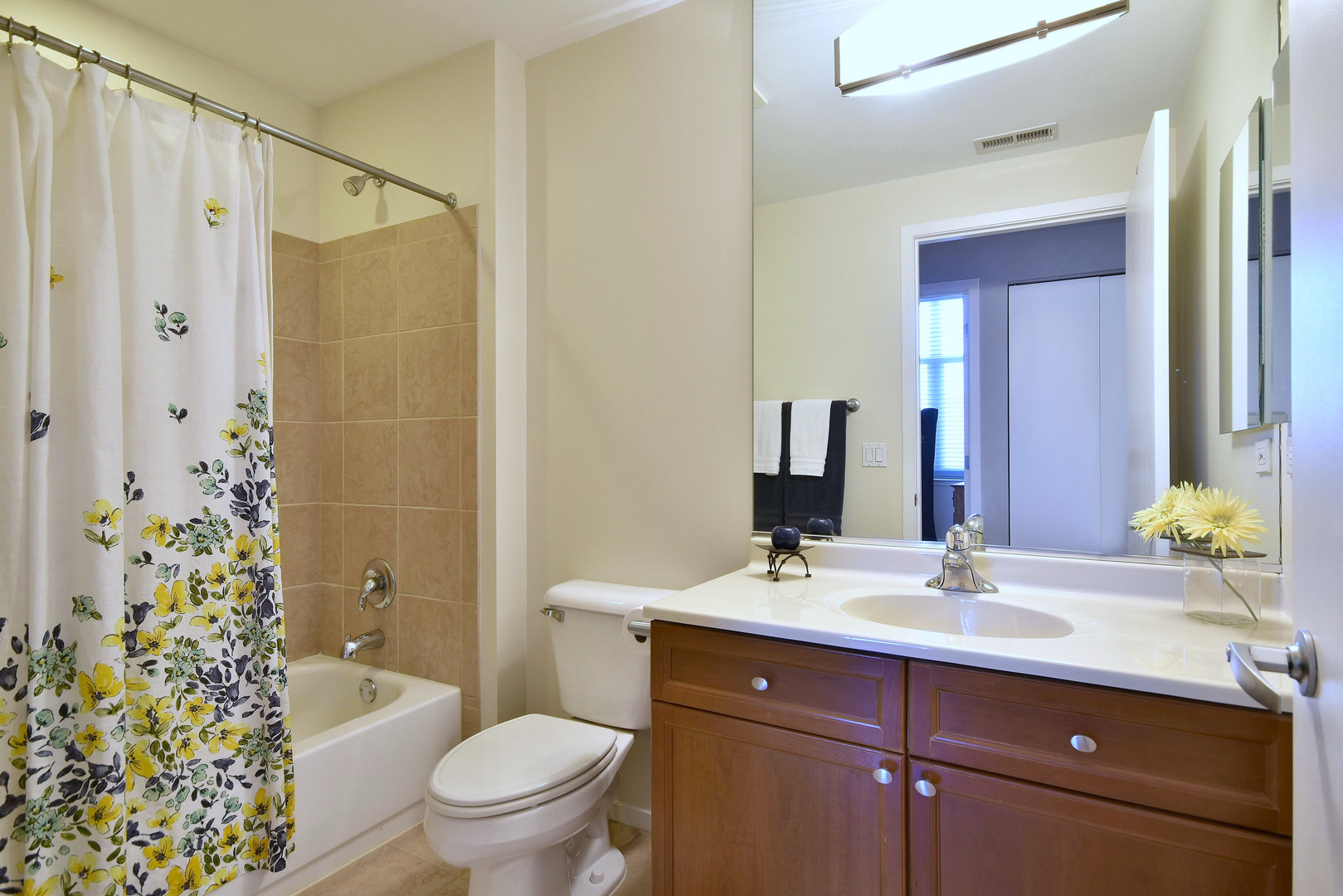 1201 West Adams Street, Unit 411 Chicago, IL 60607 - Photo 30 of 40 a bathroom with a sink a toilet a mirror a vanity and shower