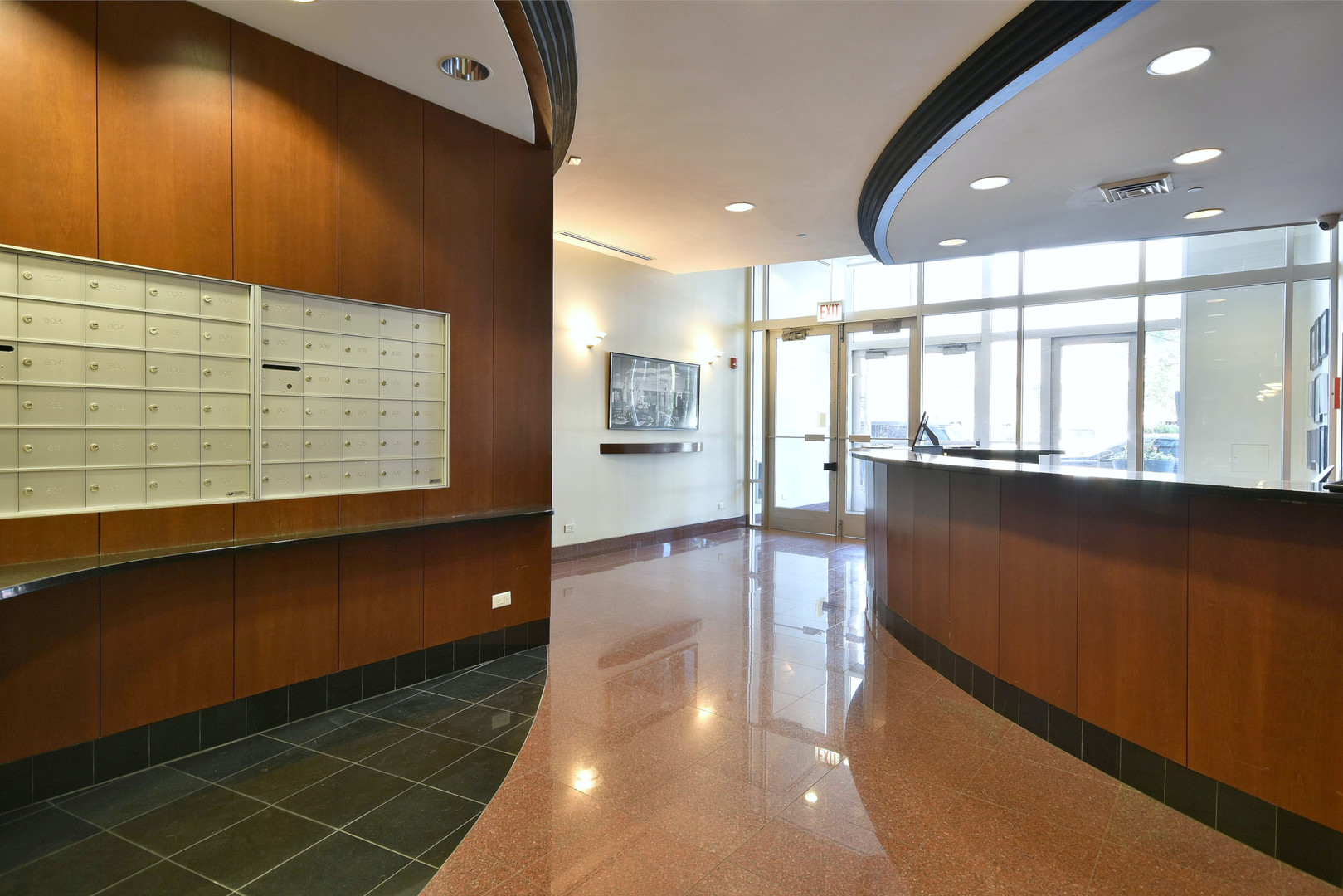 1201 West Adams Street, Unit 411 Chicago, IL 60607 - Photo 39 of 40 a view of a hallway with wooden floor and chandelier