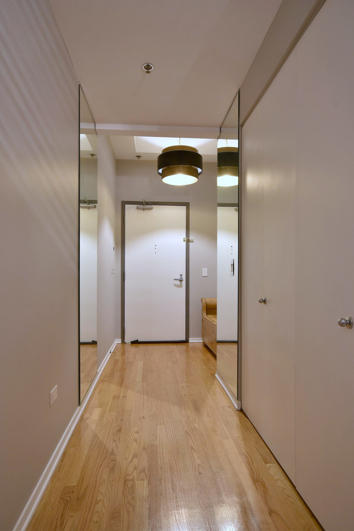 1201 West Adams Street, Unit 411 Chicago, IL 60607 - Photo 4 of 40 a view of a hallway with wooden floor