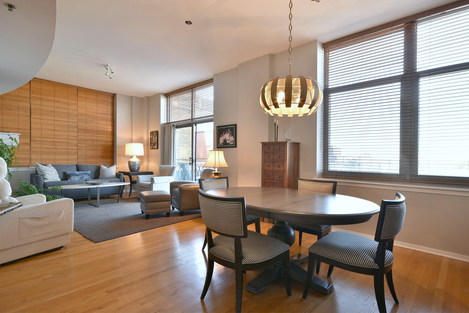 1201 West Adams Street, Unit 411 Chicago, IL 60607 - Photo 5 of 40 a view of a dining room with furniture window and wooden floor