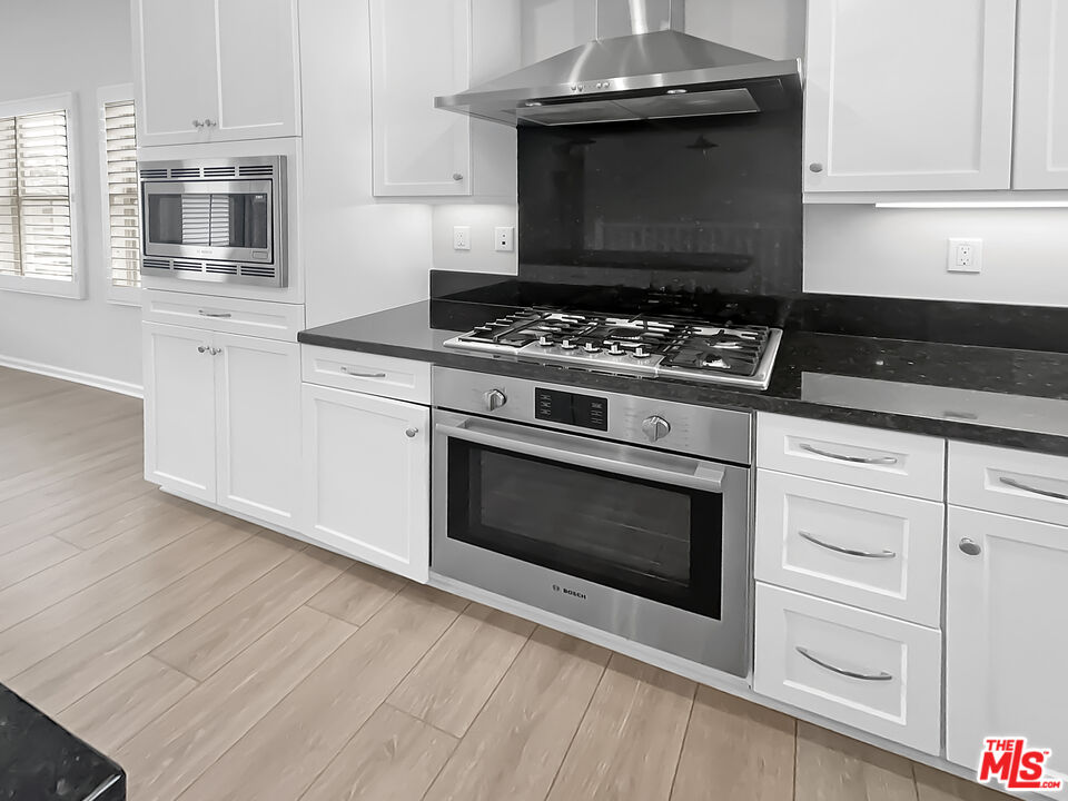 50 Evening Sun Irvine, CA 92620 - Photo 13 of 15 a stove top oven sitting inside of a kitchen