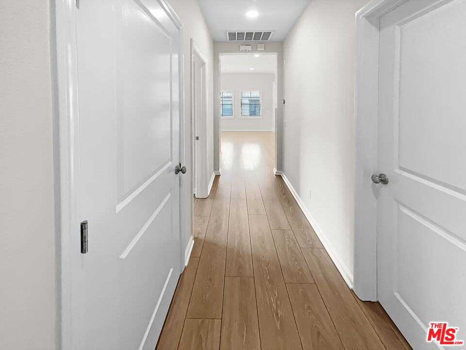 50 Evening Sun Irvine, CA 92620 - Photo 15 of 15 a view of a hallway with wooden floor and staircase