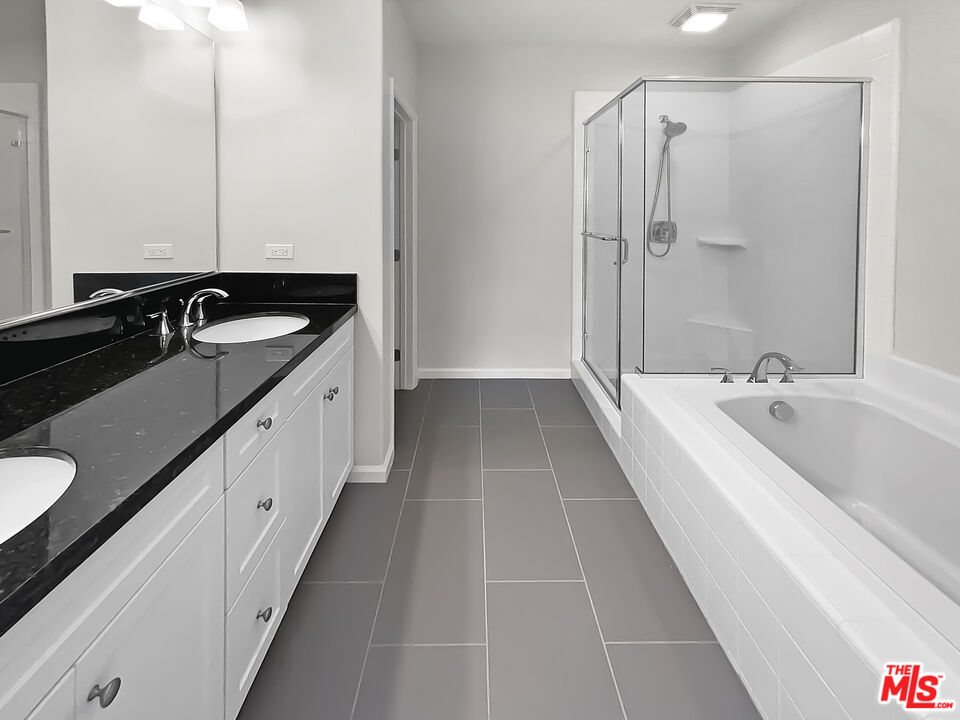 50 Evening Sun Irvine, CA 92620 - Photo 6 of 15 a bathroom with a double vanity sink and mirror