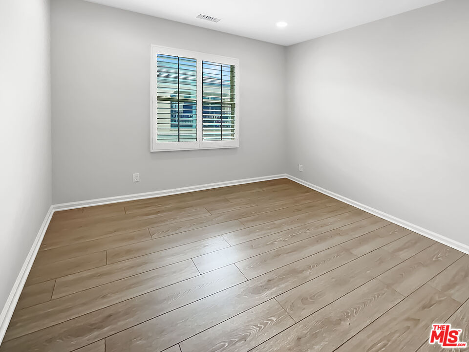 50 Evening Sun Irvine, CA 92620 - Photo 10 of 15 an empty room with wooden floor and windows