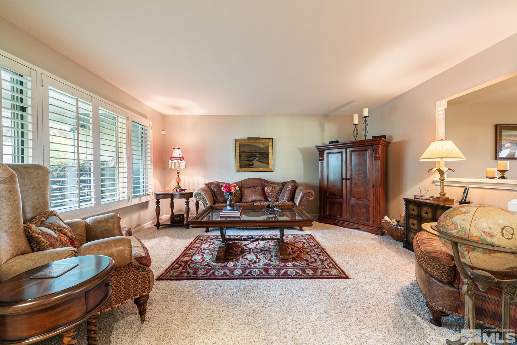 2025 Heatheridge Lane Reno, NV 89509 - Photo 18 of 40 a living room with furniture a rug a lamp and a large window