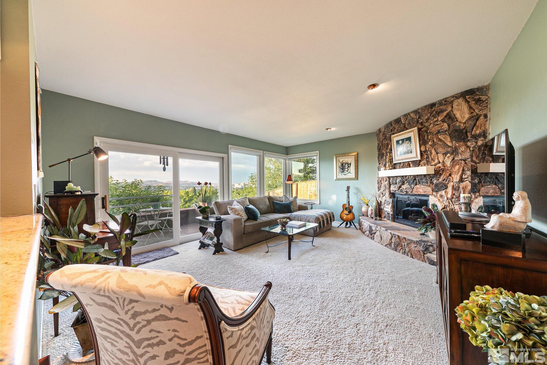 2025 Heatheridge Lane Reno, NV 89509 - Photo 28 of 40 a living room with furniture a fireplace and a floor to ceiling window
