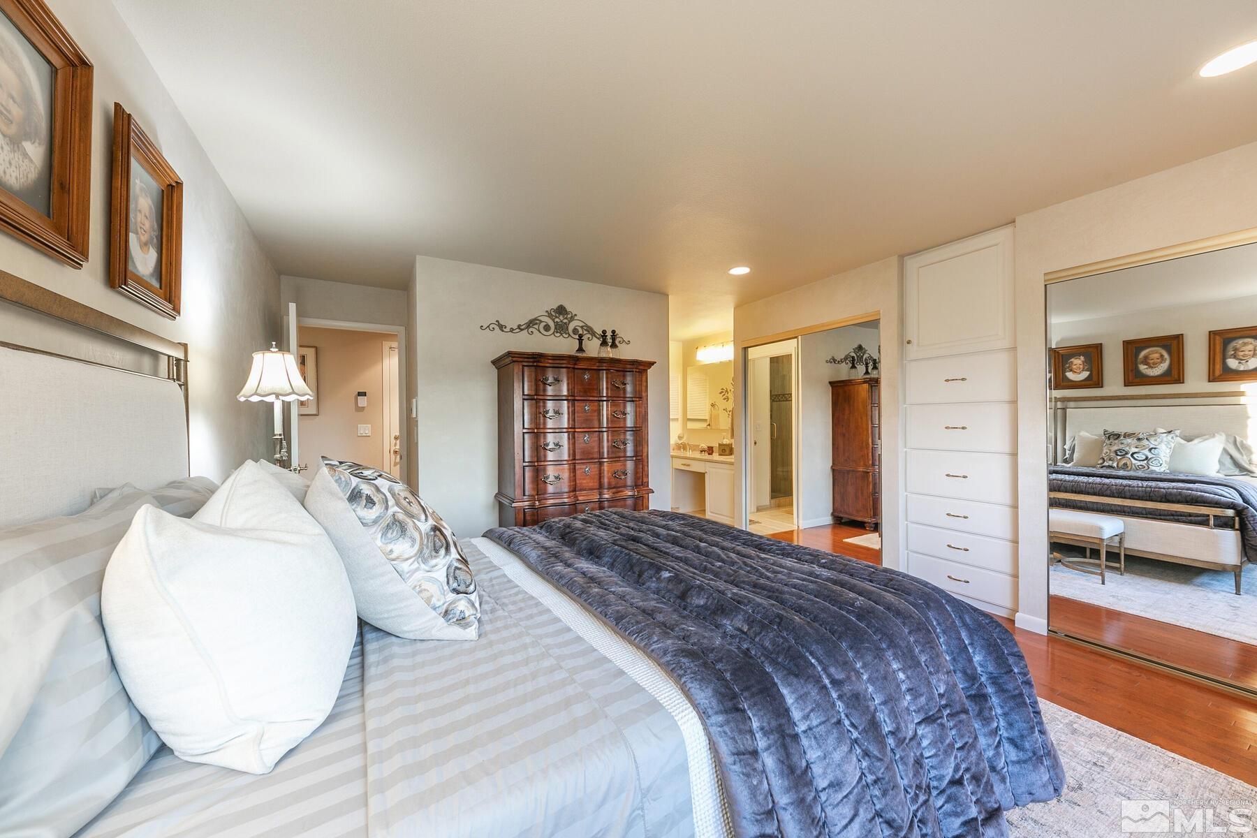 2025 Heatheridge Lane Reno, NV 89509 - Photo 34 of 40 a spacious bedroom with a large bed and a wooden floor