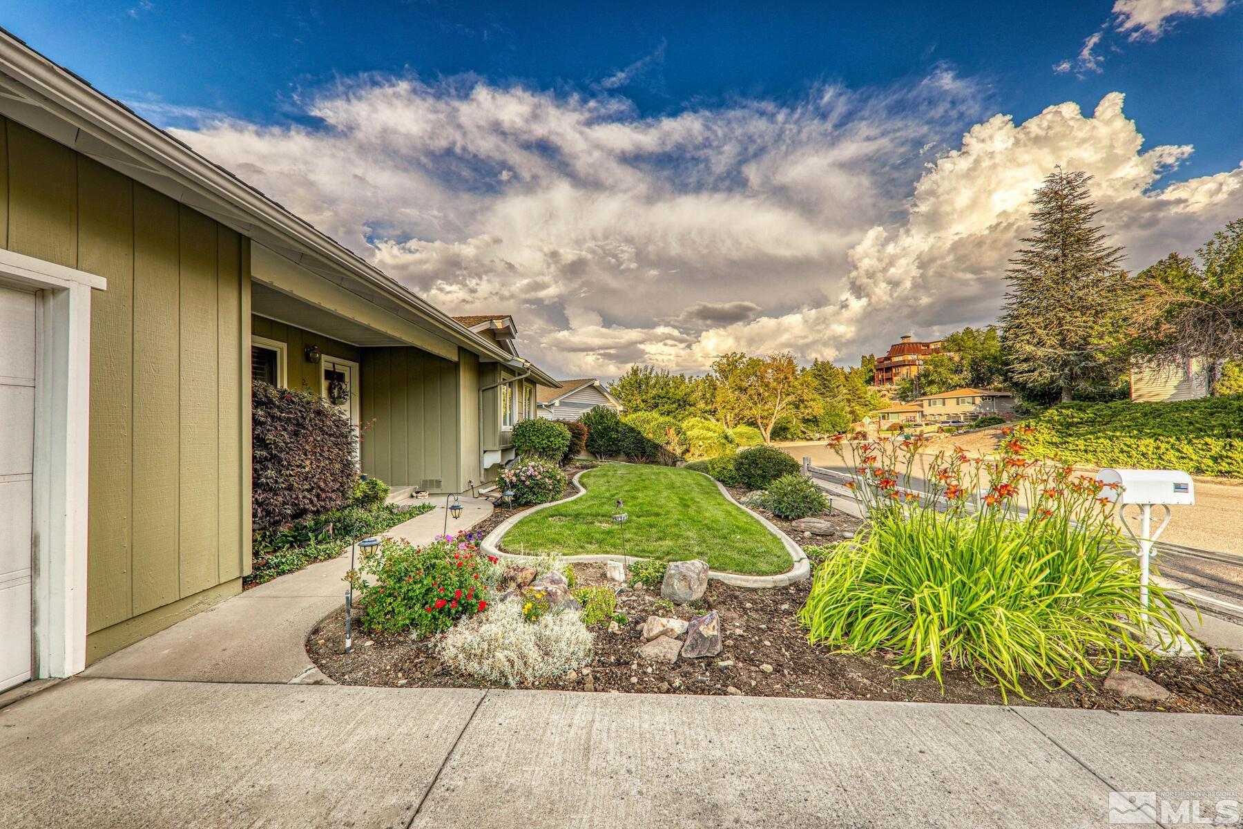 2025 Heatheridge Lane Reno, NV 89509 - Photo 4 of 40 a front view of a house with a yard and potted plants