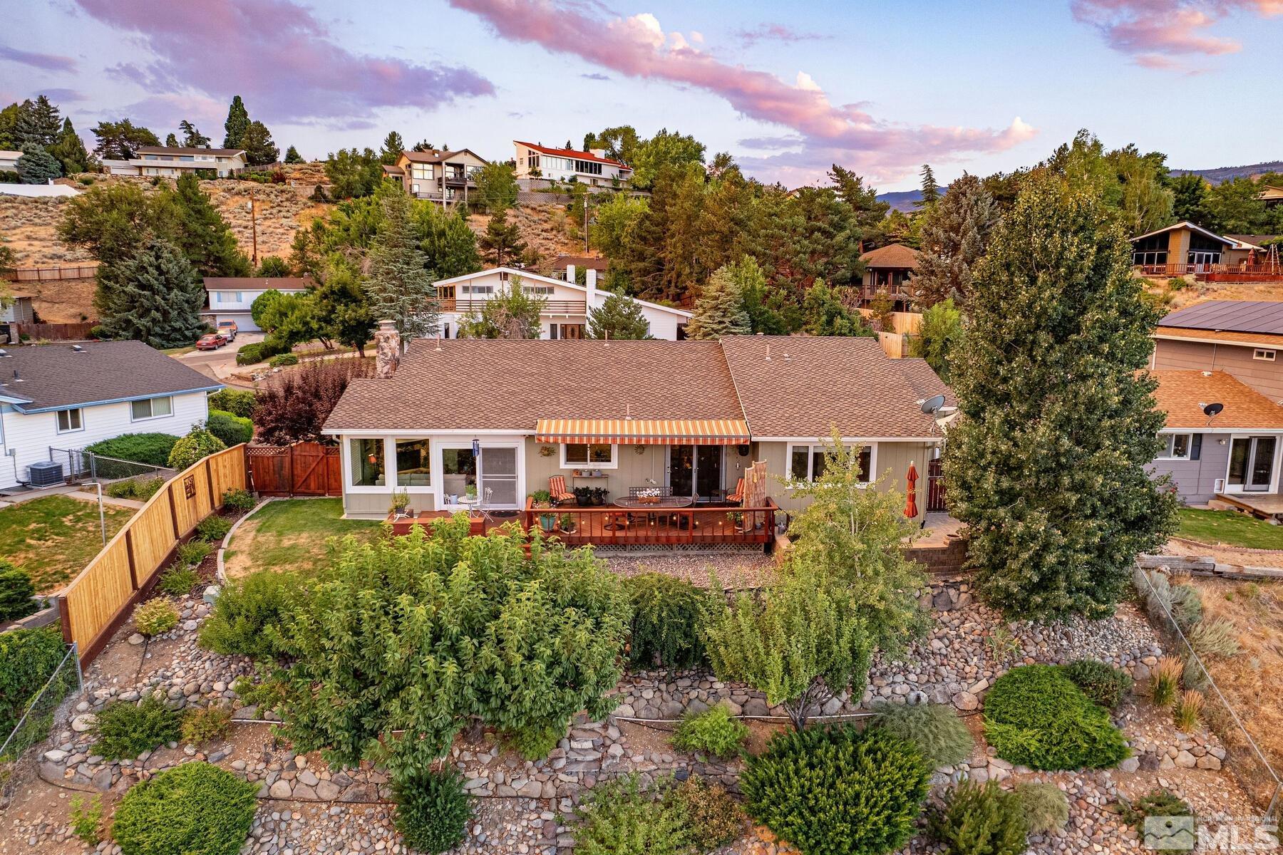 2025 Heatheridge Lane Reno, NV 89509 - Photo 6 of 40 a view of a big house with a big yard and large trees
