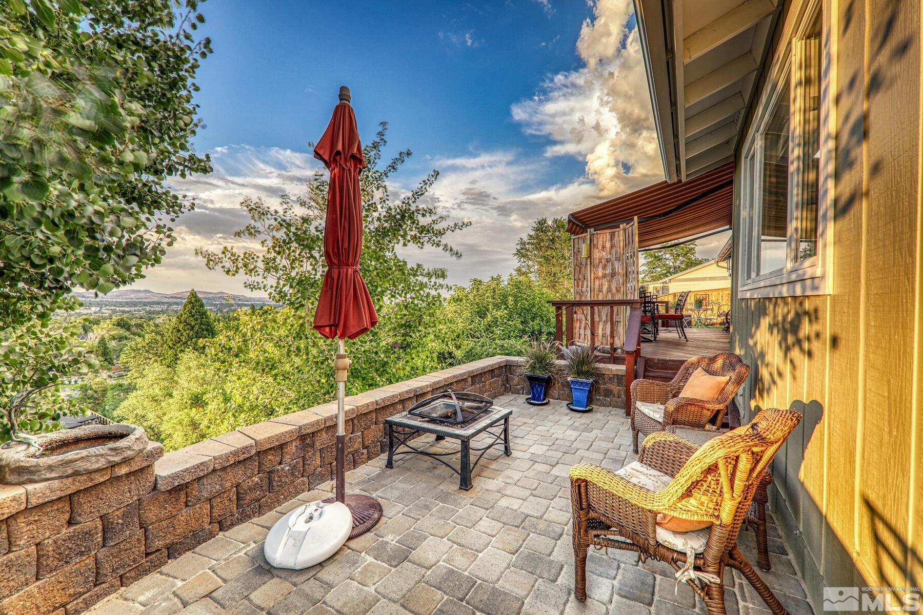 2025 Heatheridge Lane Reno, NV 89509 - Photo 10 of 40 a roof deck with table and chairs and potted plants