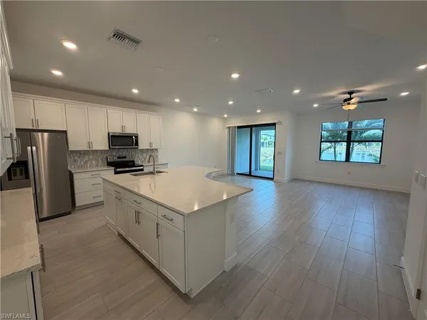 a kitchen with a stove a refrigerator and a microwave