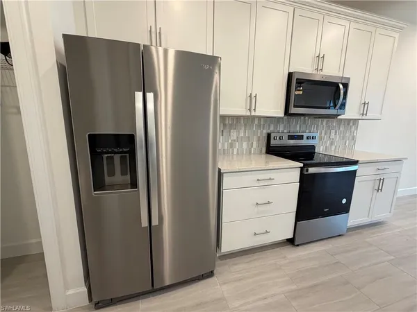 a kitchen with a refrigerator stove and microwave
