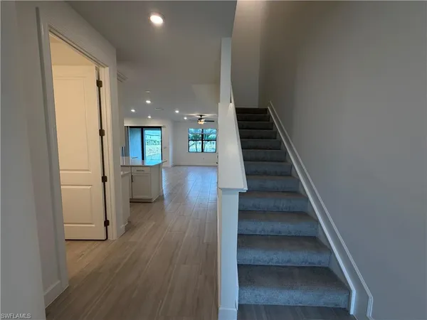 an empty room with a window and a ceiling fan