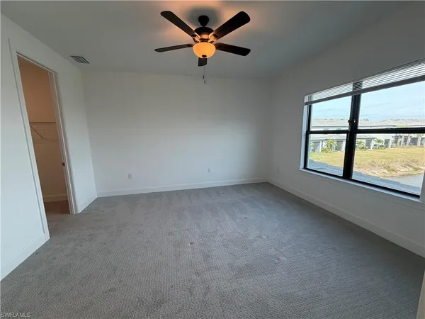 a view of a livingroom with a ceiling fan and window