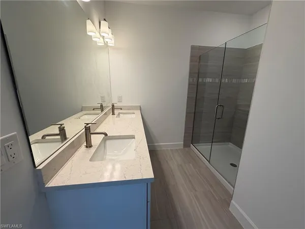 a bathroom with a sink a mirror and vanity