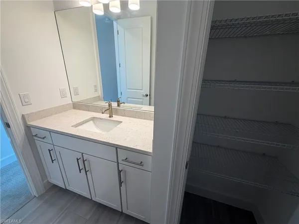 a bathroom with a white toilet and bathtub