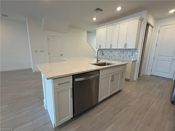 a kitchen with a sink stove and cabinets