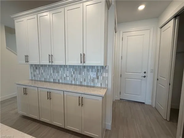 a kitchen with white cabinets