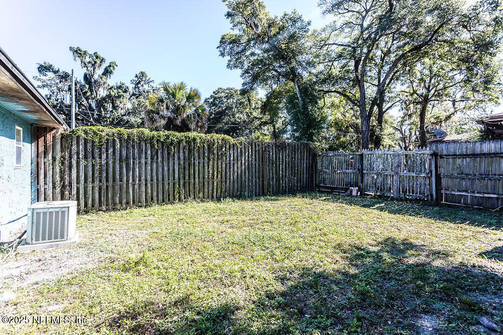 5328 Arlington Road Jacksonville, FL 32211 - Photo 13 of 16 a view of backyard with wooden fence and trees