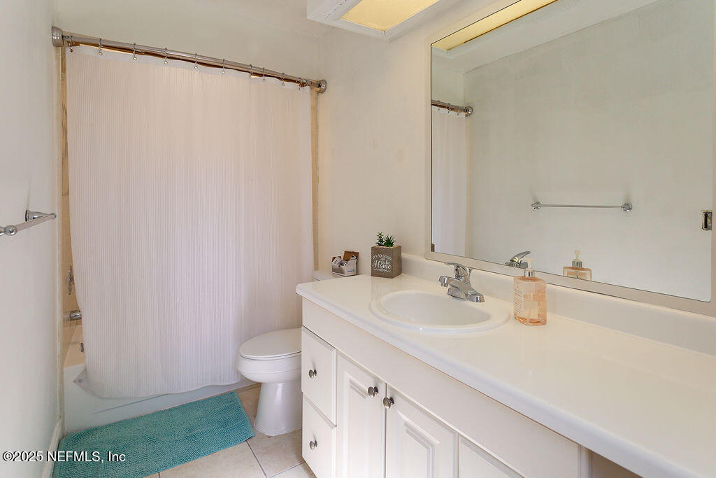 5328 Arlington Road Jacksonville, FL 32211 - Photo 16 of 16 a bathroom with a sink a toilet and a mirror